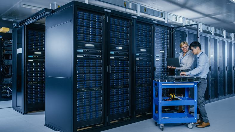 Two IT workers in a server room