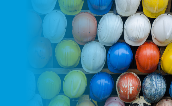 Many colorful hard hats arranged in rows